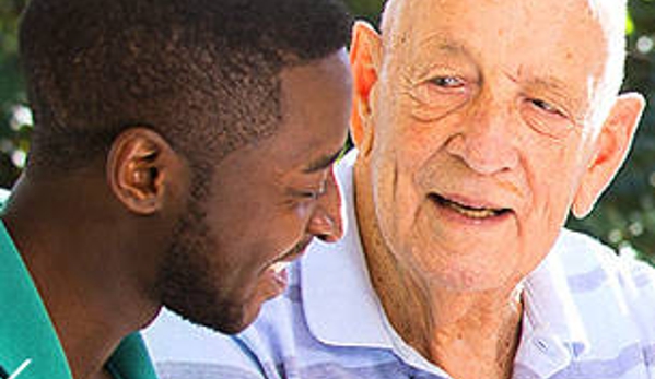 Amana Living - Cottesloe, WA. A resident and his carer outdoors