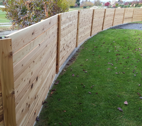 Osorio's Quality Landscaping. Curved wooden fencing
