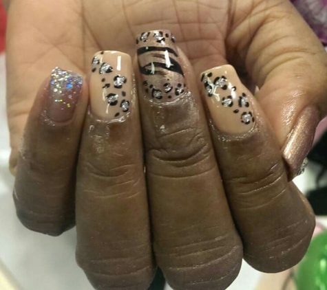 Luxy Nail Salon - Las Vegas, NV. There seems to be acrylic and glue around her cuticles and fingertips, and nails aren't sized right