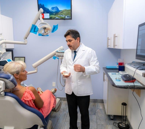 Dental Beauty - Feasterville Trevose, PA. Dr. Andrey Kurudimov explaining dental veneers cosmetic dentistry procedure to patient at Dental Beauty Feasterville PA