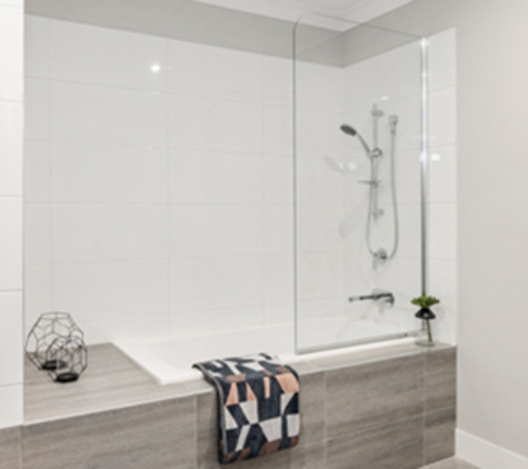 Bradnam's Windows & Doors - Bungalow, QLD. Fixed Shower Screen Above A Bath