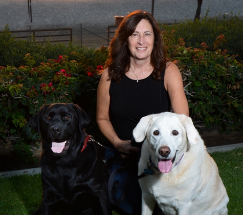 Farmers Insurance - Lisa Newell - San Clemente, CA. Lisa with the shop dogs!