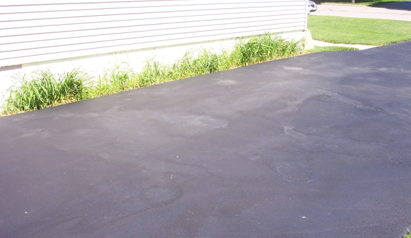 Still Sealcoating - Mukwonago, WI. After Rain Wash Out,Oily spots from sealer separating from rain!