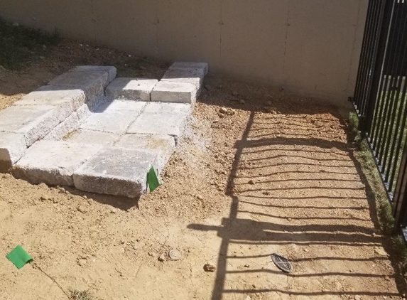 No LIMIT IRRIGATION - Wentzville, MO. There is no base unders this step and it is already washing away. he didnt dig dow to be level with the fence.