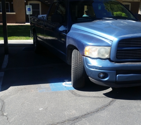 Family Property Management - Las Vegas, NV. Maintenance illegally parked in covered handicap for residents.