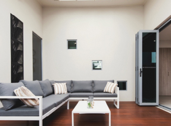 Bradnam's Windows & Doors - Bungalow, QLD. Ultra Silver Aluminium Bi-Fold Door With Grey Glass
