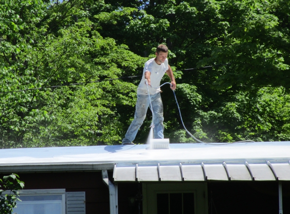 IOK Carpentry - Greene, NY. Ivan applying the Conklin Roof Coating