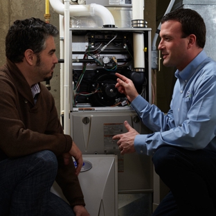 Green Home Solutions Heating and Cooling, Insulation - Cleveland, OH. A licensed and certified GHS technician installs a Carrier furnace system.