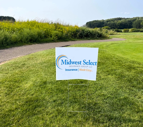 Midwest Select Insurance Group - Kronenwetter, WI. Midwest Select Insurance Group - Insurance Made Easy sponsorship poster surrounded by bright green grass on a sunny Wisconsin summer day.