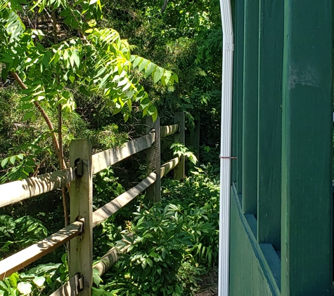 Morelands Guttering - Winchester, VA. Section of downspouts that are crooked, top to bottom.  Very unsightly.