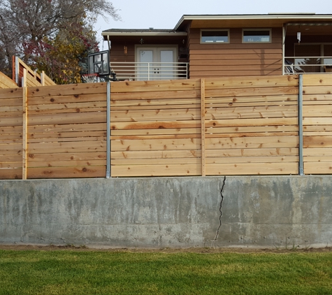 Osorio's Quality Landscaping. Fence installed on existing concrete wall