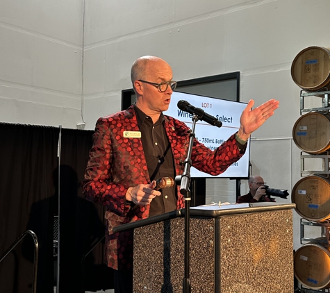 Gavelo Auctions - Seattle, WA. Auctioneer Nelson Jay selling wine at the 2024 AWW Private Barrell Auction, a benefit for WSU Viticulture and Enology Program.