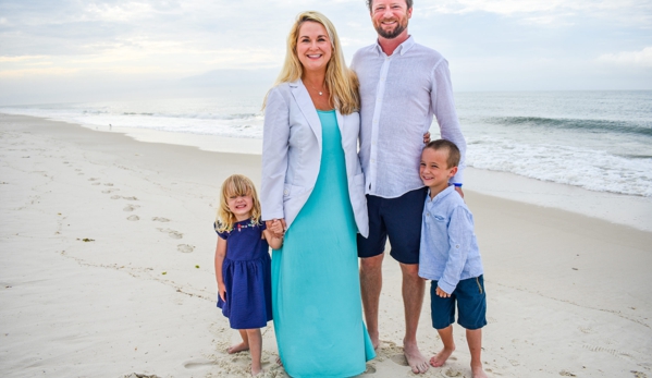 Edwards, Pamela, DDS - Gulf Shores, AL. Dr. Mary Edwards Long wearing her white doctor's coat standing on the beach in Gulf Shores and Orange Beach with her two  children