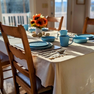 Bed and Breakfast at Asheville Farm - Leicester, NC. dining room table is nearly surrounded by windows