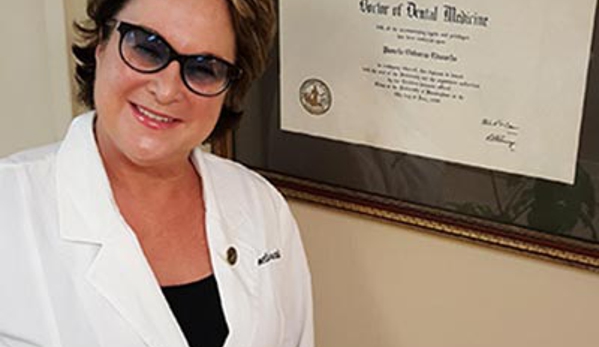 Edwards, Pamela, DDS - Gulf Shores, AL. Dr. Pamela O. Edwards in front of her diploma wearing her white doctor coat with a bright white smile