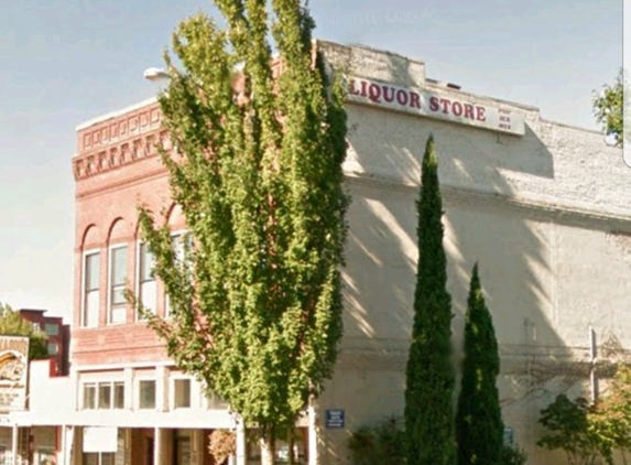 Downtown Salem Liquor Store - Salem, OR. Historic brick building next to Umqua Bank, Ace of Fades barber shop and Magoo's  Tavern.