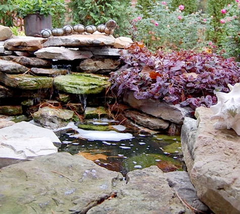 French Masonry - Imperial, MO. Natural rock and stone coy pond with working waterfall. Decorative stone and rock art.