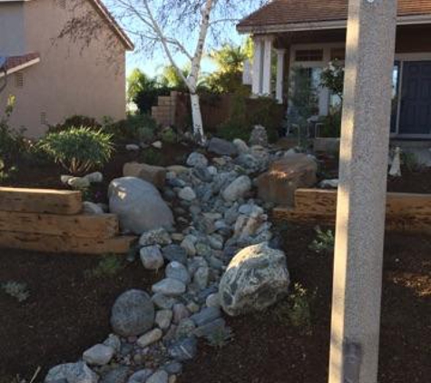 Medina's Landscaping - Newhall, CA. Multi-level rocks, shrubs, and mulch create a dynamic look.