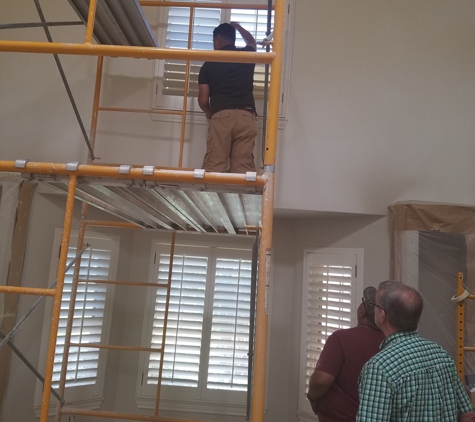 Corner Window The - Lubbock, TX. Teamwork hanging Shutters