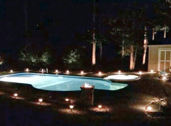 Backyard Oasis Pool Store - York, SC. Stunning 16' × 32' key west with spill over spa and a amazing light show by: Backyard Oasis Pools and Construction