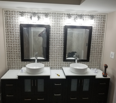 Absolute Interiors and Design, LLC - Cleveland, OH. Mosaic tile accent wall with multi tiered double vessel sink vanity
