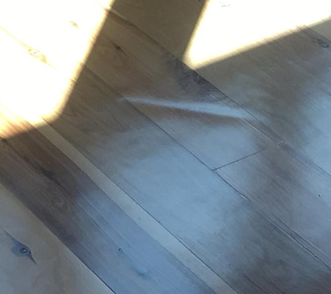 Superior Floor Sanding & Polishing - Wollongong, NSW. Barrel gouge in Kitchen floor in front of sink. "Put a mat over it", I don't think so.