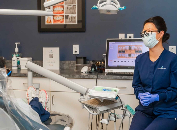 Family Dental Choice - Charlotte, NC. Dental hygienist and cosmetic dentistry patient sharing lighter moments at Family Dental Choice