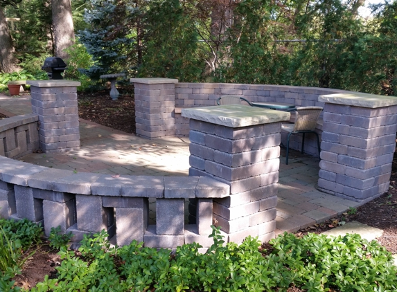 Earthworks Design, Inc - Silvis, IL. Stone patio with seating and stone piers