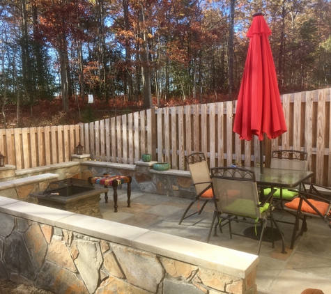 American Veteran General Contractors - Ellicott City, MD. Flagstone patio with sitting walls