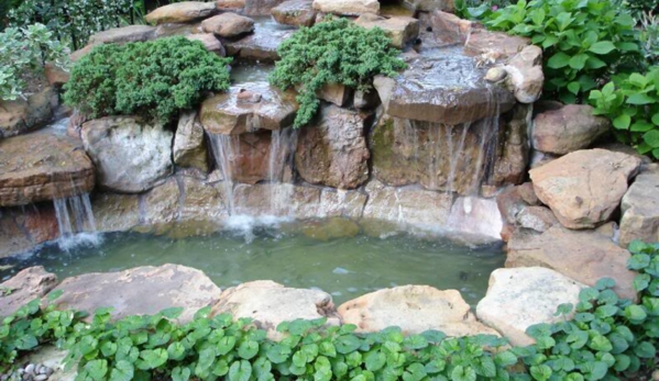 Houston masonry pond - Houston, TX. Regular pond with its own unique stone waterfall