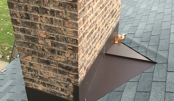 Watkins  Construction &  Roofing - Jackson, MS. Custom pre painted aluminum chimney flashing with cricket to divert water away from back side. 
