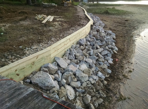 Raintree Landscape - Gadsden, AL. Reskin plank seawall and rip rap with 2" gravel, 100-200# stones