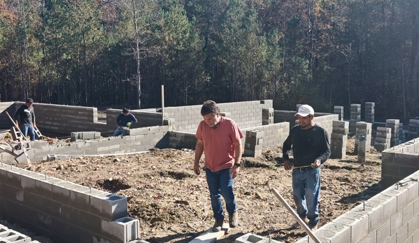 Four Oaks Residential - Four Oaks, NC. Manager and head mason discussing "parge coating" the foundation.