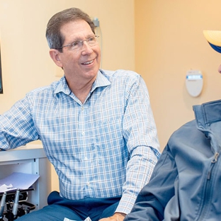 The Silberman Dental Group - Waldorf, MD. Waldorf dentist Dr Paul B Silberman laughing with a patient at The Silberman Dental Group