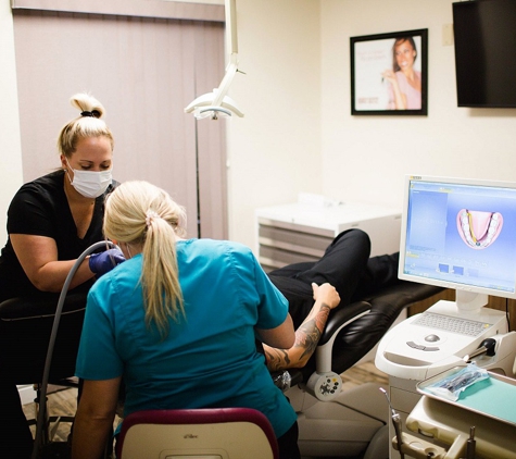 Winter Park Dental - Winter Park, FL. Dental assistants at work with root canal patient at Winter Park Dental