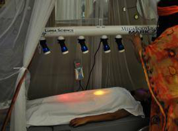 The Ra Natural Health Education Center - Dorchester Center, MA. Chakra Balancing under warm color lights over massage mechanical bed (heavenly)
