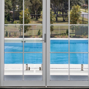 Bradnam's Windows & Doors - Gladstone Central, QLD. White Aluminium Hinged Door With Colonial Bars