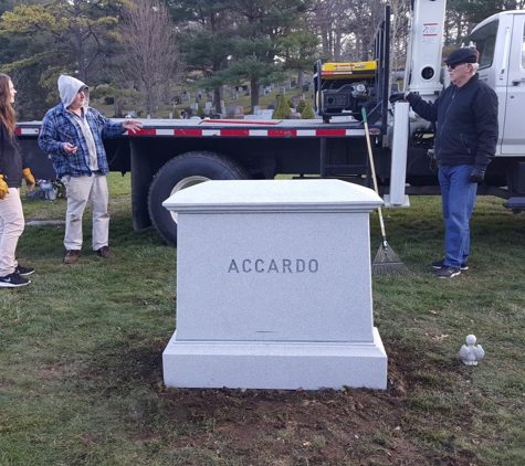 Vermont Stone Sculpturing, Inc. - Williamstown, VT. Customer watching as  we set their beautiful handcrafted monument by KM.