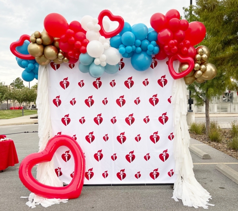 From Me 2 You Creations - Springdale, AR. Balloon Garland on Backdrop for American Heart Association