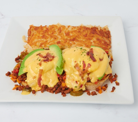 Shen Lonestar - Aubrey, TX. English muffin, chorizo, avocado, jalapeños, topped with sweet peppers and chives, hollandaise sauce, chives