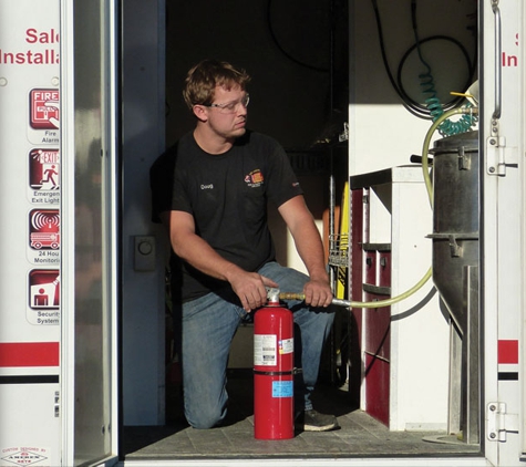 Fox Valley Fire & Safety Co.. Fox Valley Fire & Safety's fire extinguisher service technician recharging fire extinguisher in Wheaton, IL