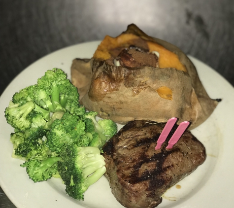 Logan's Roadhouse - Ruston, LA. Filet mignon cooked medium rare combined with steamed broccoli and sweet potato