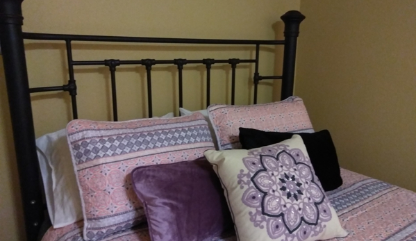 Iola's Home Away Extended Stay - DeRidder, LA. Guest Bedroom Queen Bed