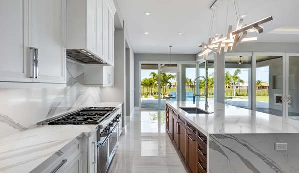 Euro Floors - Pompano Beach, FL. Kitchen Countertops with full stone backsplash and island with waterfalls - Residential Project
