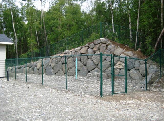 Wasilla Fence Co. fenced dog run rock wall