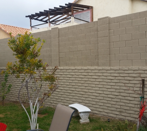 Building Block Masonry - Phoenix, AZ. 5 ft tall retaining wall with a 5 ft tall block fence on top both painted