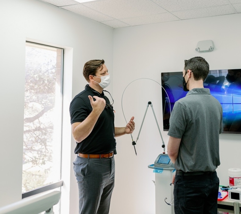 Smile Team Pediatric Dentistry - Fort Worth, TX. Medicaid Pediatric dentist in Fort Worth Justin Warcup explaining dental procedures