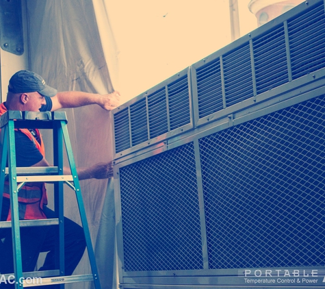 Portable Air LLC - Cocoa, FL. Vertical HVAC unit being installed at an outdoor tented event.