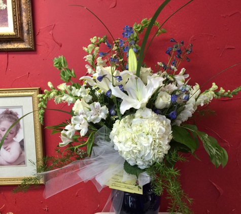 A Touch Of Class Florist - Vestavia, AL. Wonderful in white.... All white holland flowers with cobalt blue touch of flowers in a cobalt blue urn vase... VERY ELEGANT LOOK....