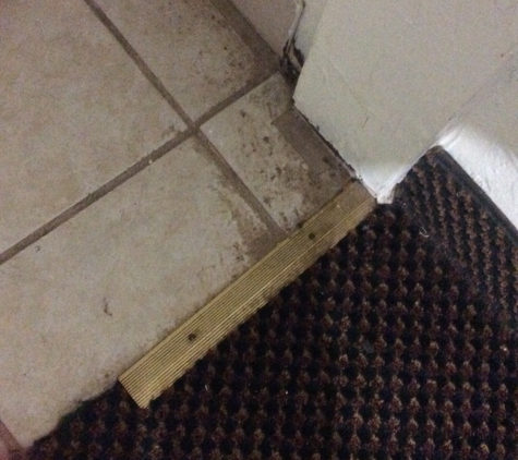 Budget Inn & Suites - Colby, KS. Dirt covering a majority of the corners in the room and bathroom